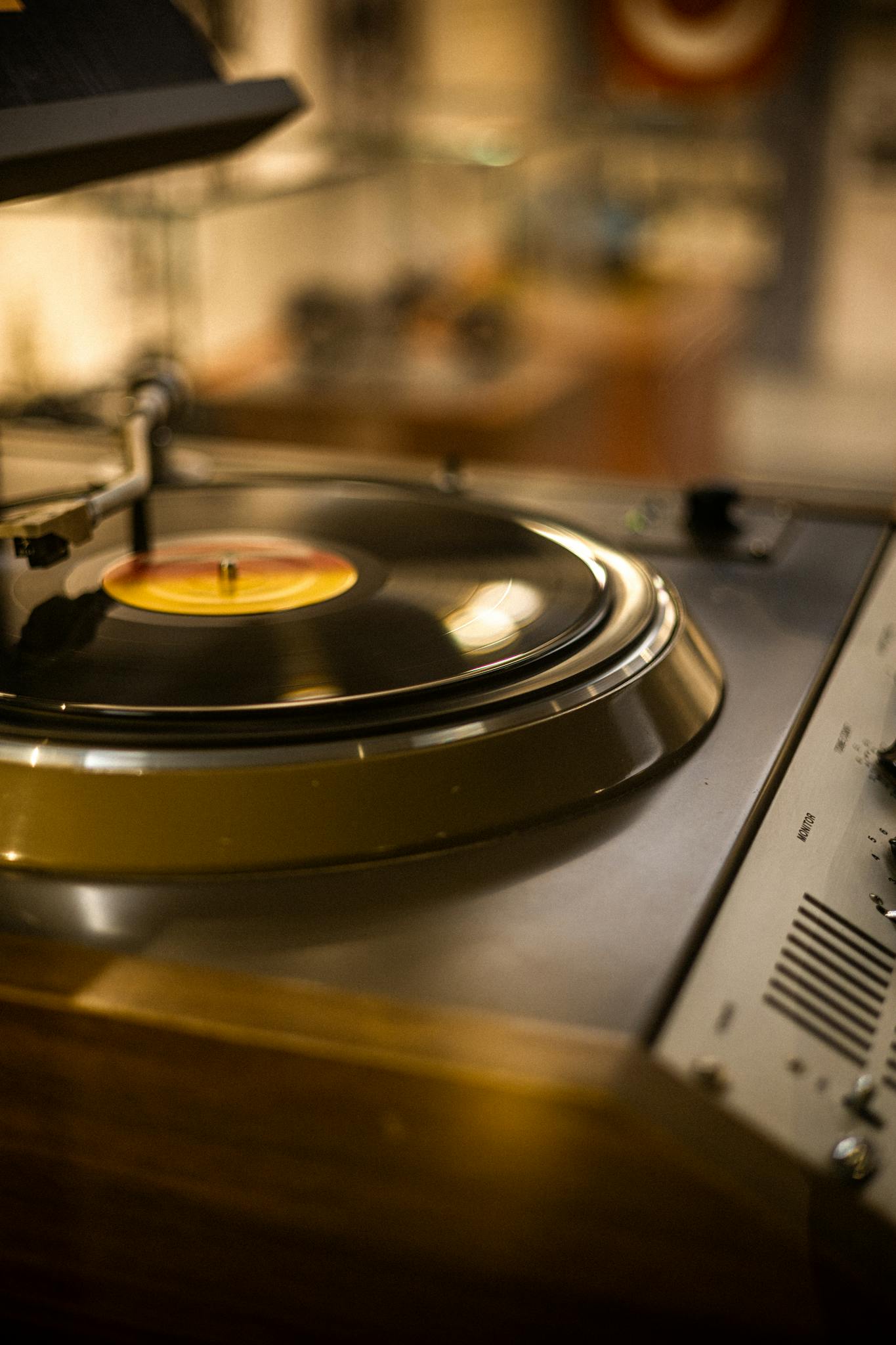 Close-up of a classic record player spinning a vinyl in a cozy indoor setting, perfect for music enthusiasts.