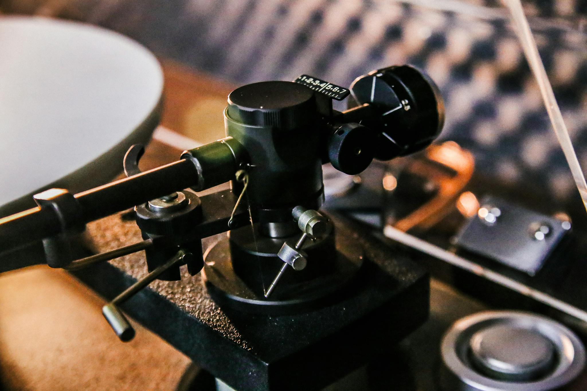Detailed close-up of a vintage turntable tonearm, emphasizing retro audio equipment.