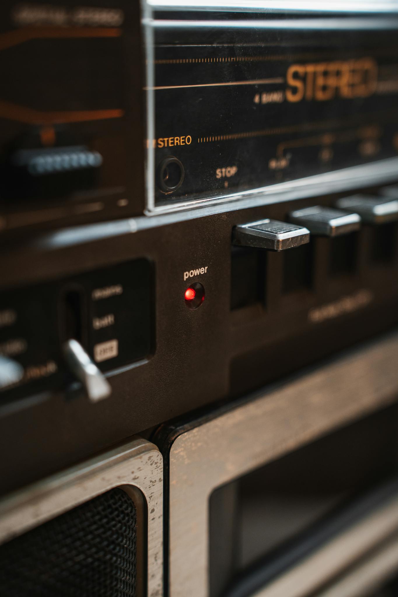 Detailed view of a vintage stereo power switch and controls, exuding retro charm.